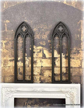 Decorative fireplace screen with gothic arches on a stone wall background