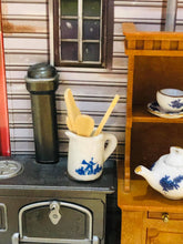 Blue jug with wooden utensils