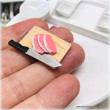 Dollhouse miniature uncooked meat knife on chopping board
