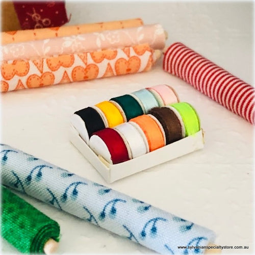 Dollhouse miniature box of ribbon rolls