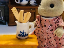 Blue jug with wooden utensils
