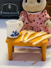 Blue jug with wooden utensils