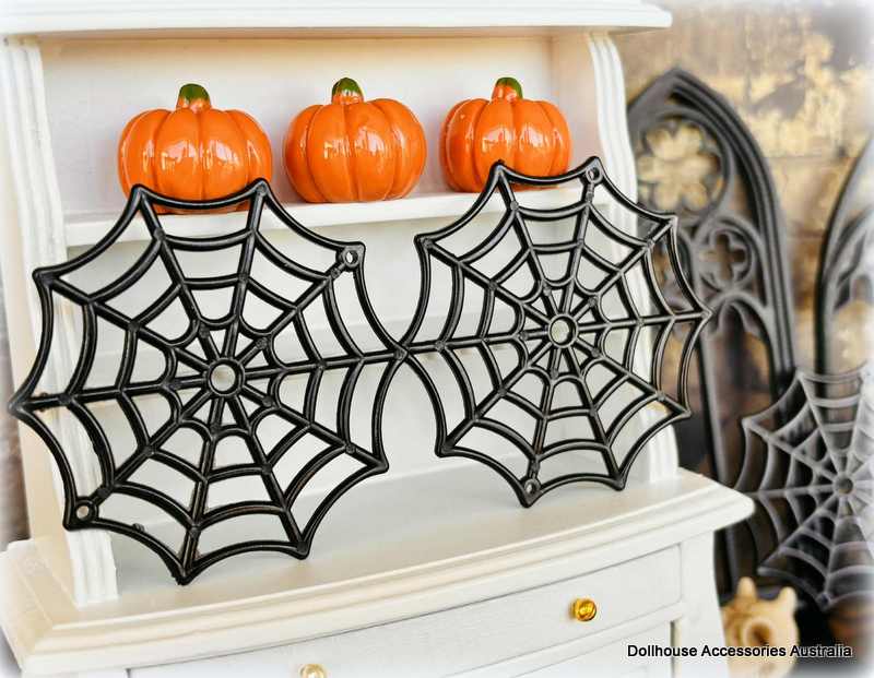 Dollhouse Miniature Halloween decorations  spider webs and on a shelf.