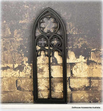 Dollhouse Gothic-style window frame against a textured stone wall background