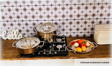 Kitchen scene with pots, a stove, and a tiled wall.