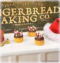 Decorative gingerbread cupcakes with candy canes on a shelf in front of a 'Gingerbread Baking Co.' sign.