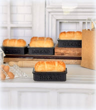 Dollhouse fresh loaf bread out of oven in baking pan