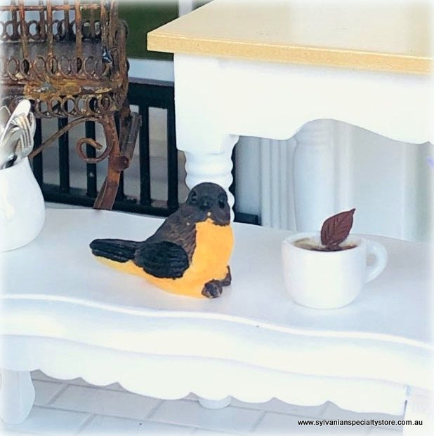Dollhouse miniature bird curious