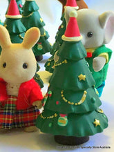 Sylvanian Families rabbit alongside Christmas tree