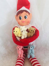 Christmas shelf elf with armful of teddy bears