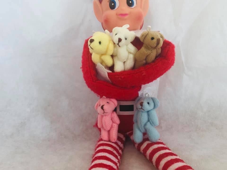 Christmas shelf elf with armful of teddy bears