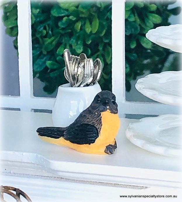 Dollhouse miniature bird curious