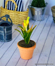 Dollhouse miniature potted plant with yellow flower