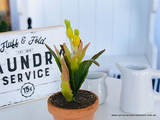 Dollhouse miniature potted plant with yellow flower