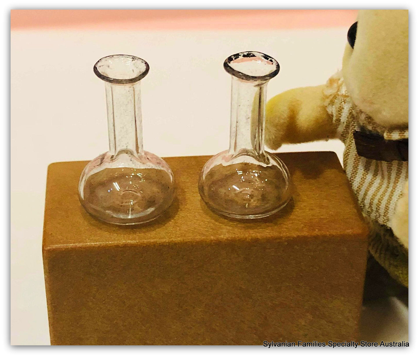 Sylvanian Families beside chemist beakers flasks lab
