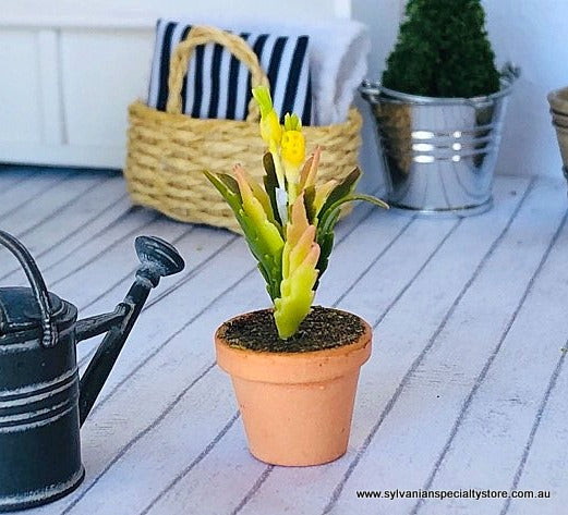Dollhouse miniature potted plant with yellow flower
